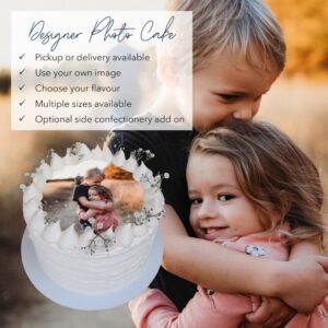 A personalized photo cake featuring two children embracing, decorated with white frosting and floral accents. photo cake, image cake, edible print cake
